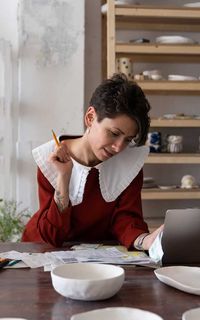 Woman calculating tax debts for loan amount