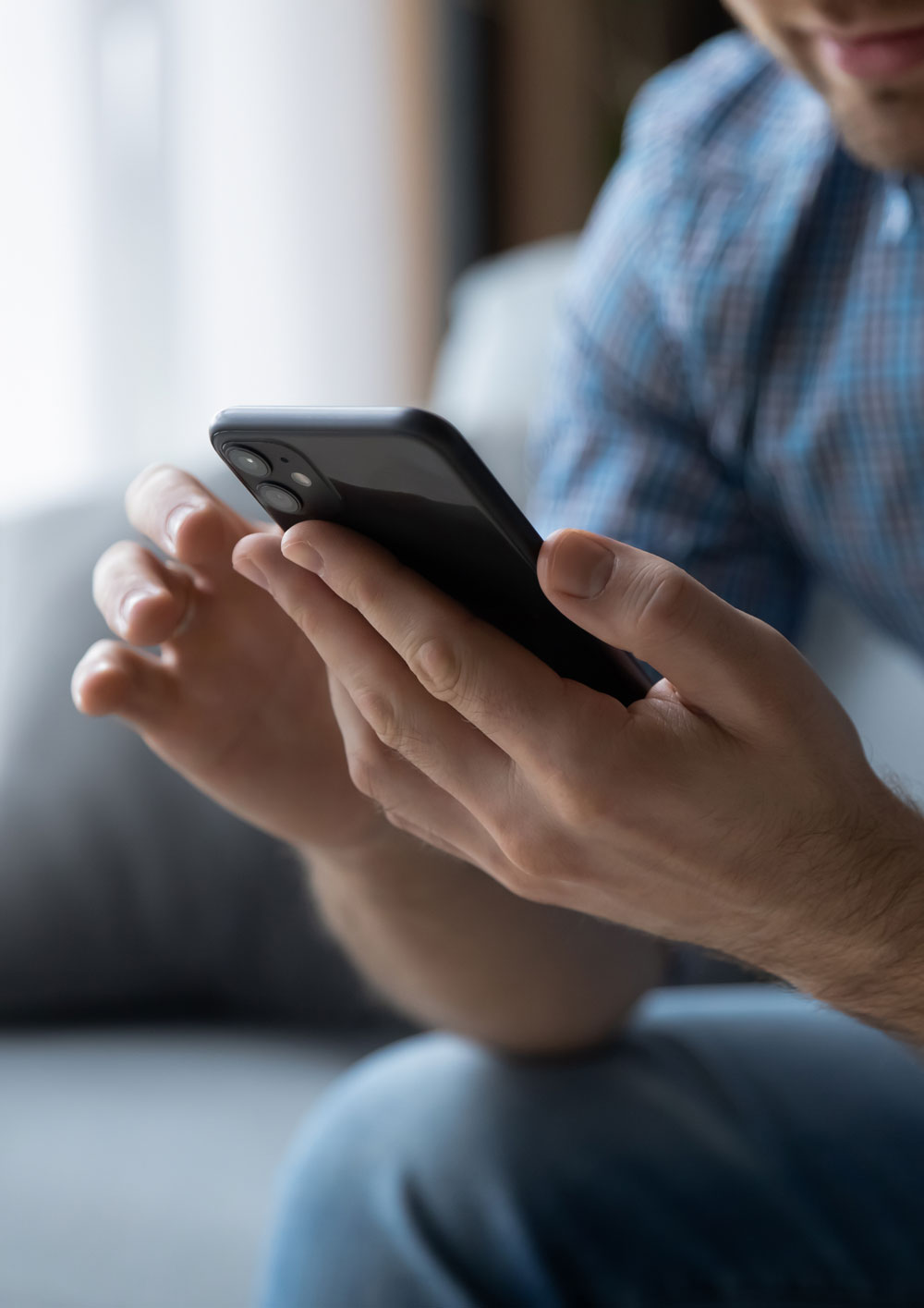 Mans hands holding a smartphone 