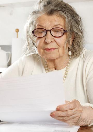 Senior woman looking at paperwork 