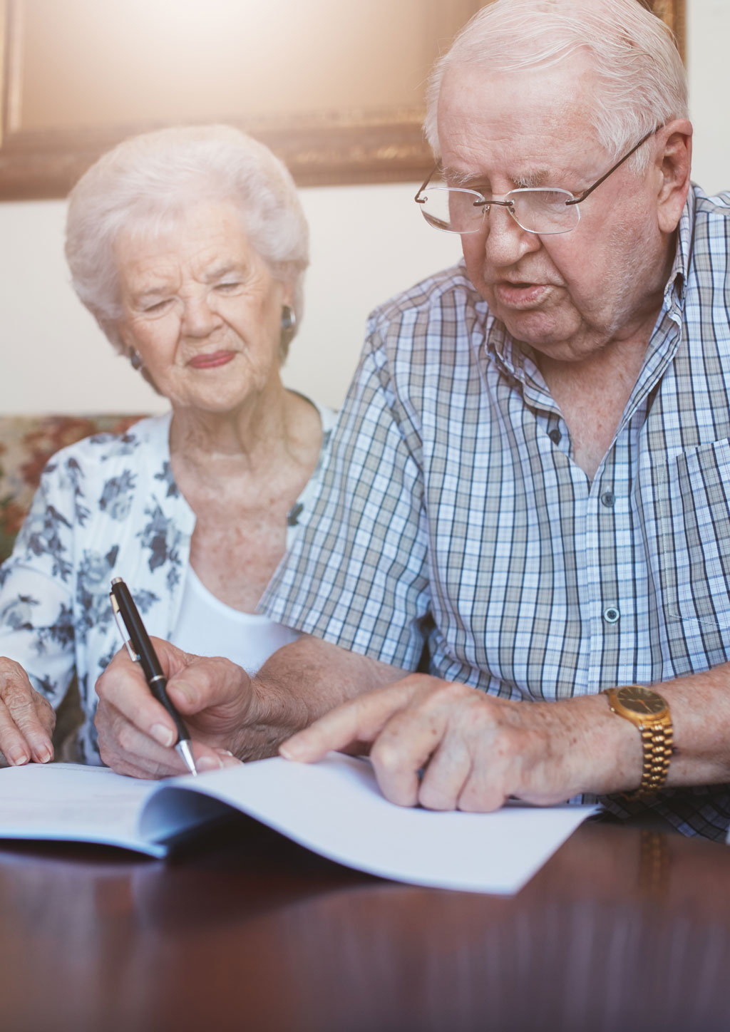 Senior couple filling out paper work