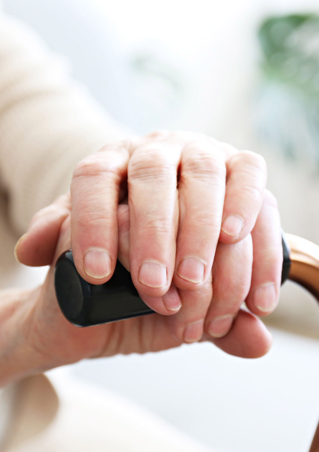 Seniors hands resting on walking frame