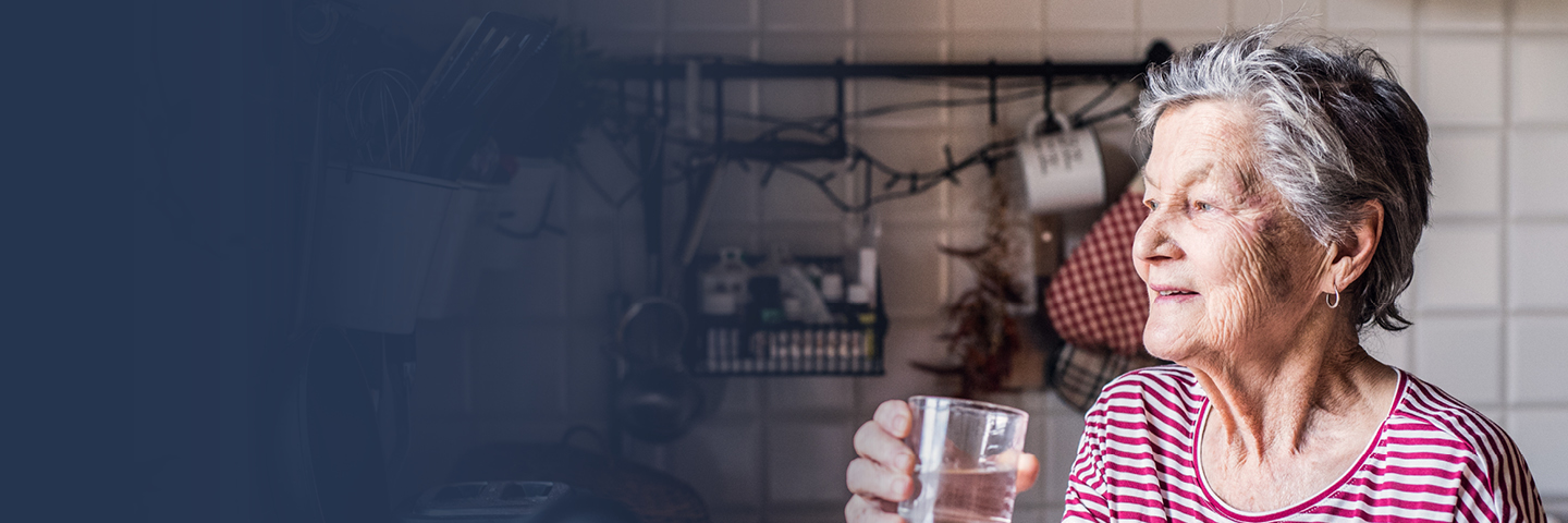 Image of an older woman drinking a glass of water
