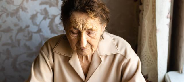 Image of an older woman looking downward