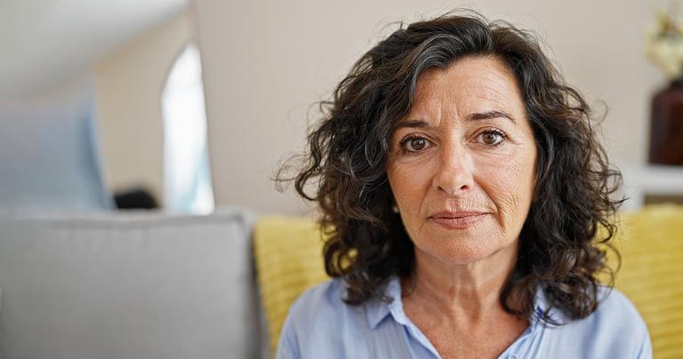 Image of an older woman with mid-length dark brown wavy hair