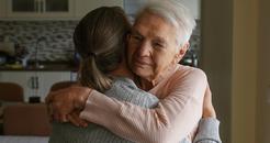 Image of an older woman and a younger woman embracing