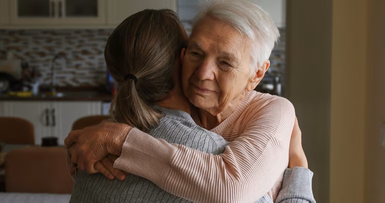 Image of an older woman and a younger woman embracing