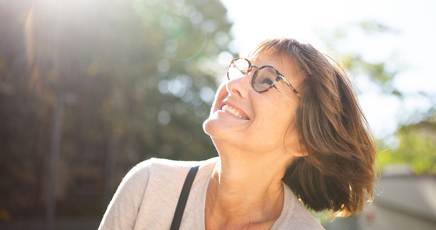 Senior woman smiling looking up to the sky