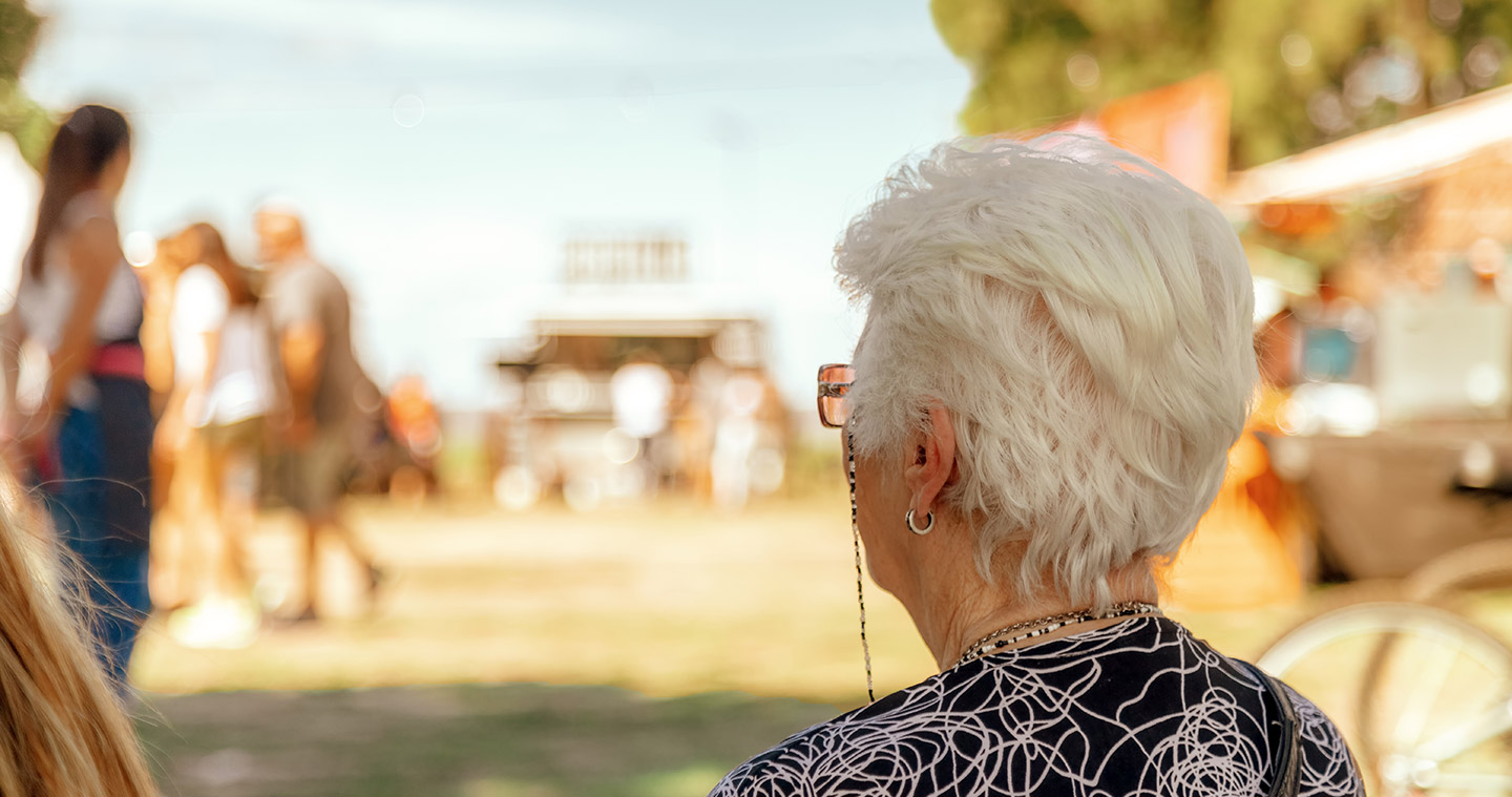 Older woman sitting down from behind