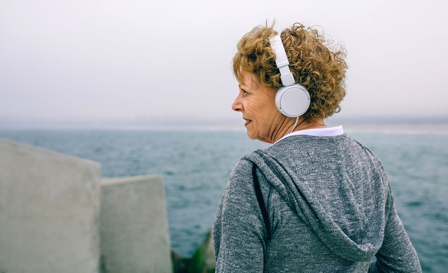 Senior woman going for a walk and listening to music