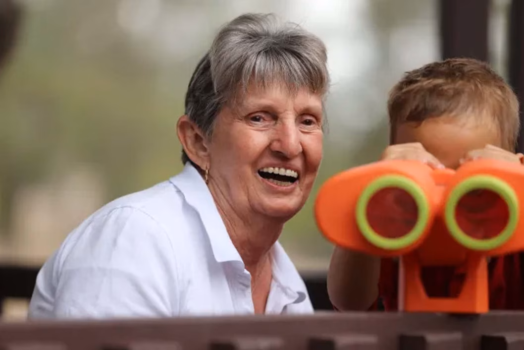 Photo of a woman with a small child and toy binoculars