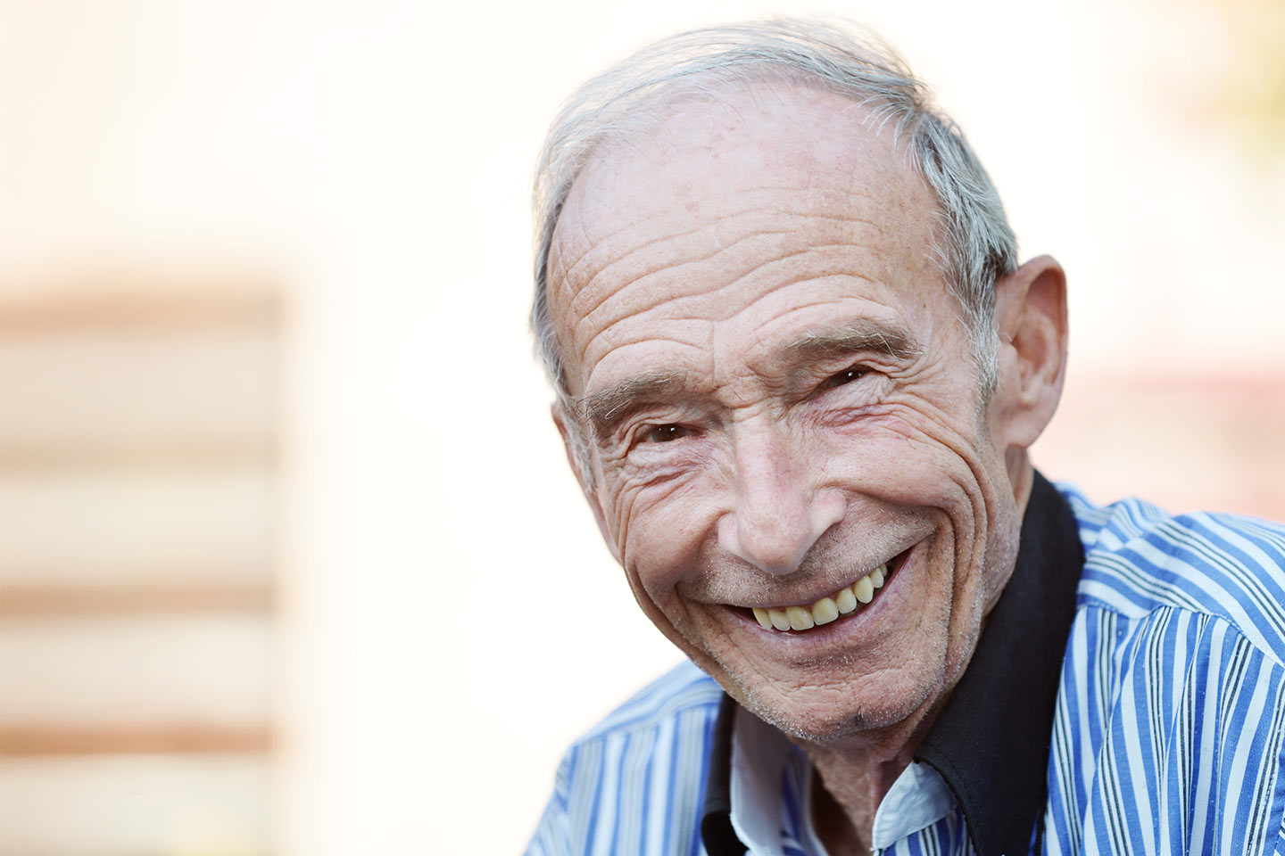 Photo of an older man smiling broadly