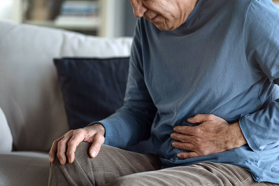 Photo of man with his hand on his stomach