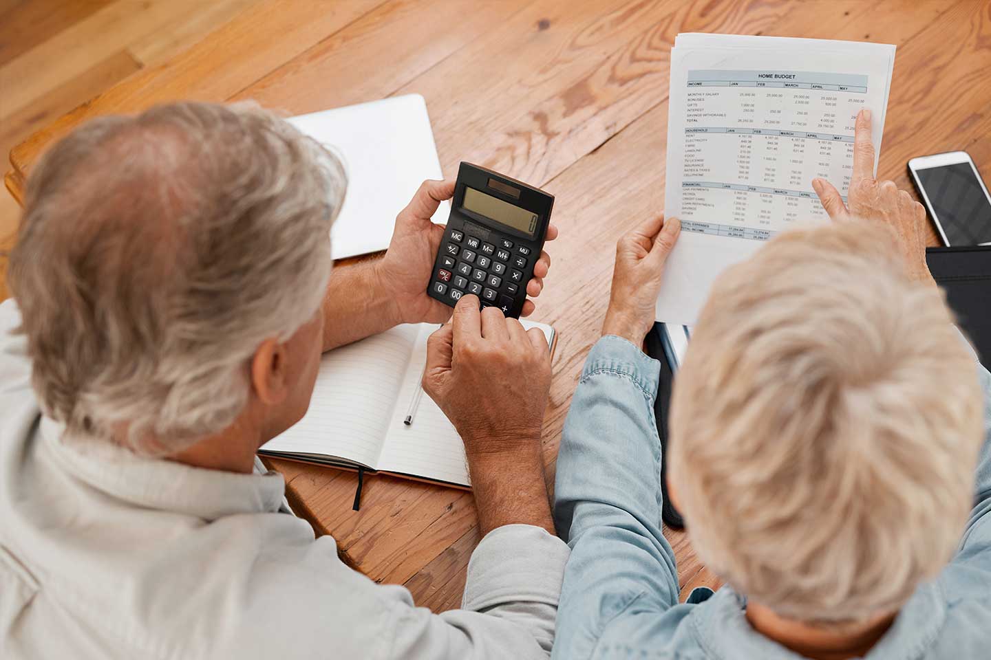 Photo of mature couple calculating their budgets