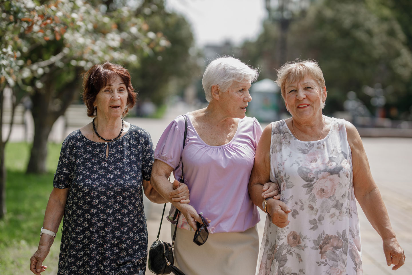 Three older women walking down the street