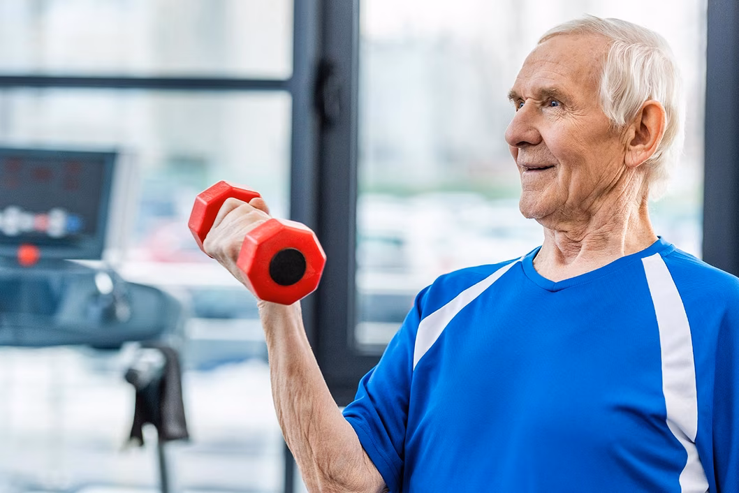 Photo of man in a gym holding a hand weight