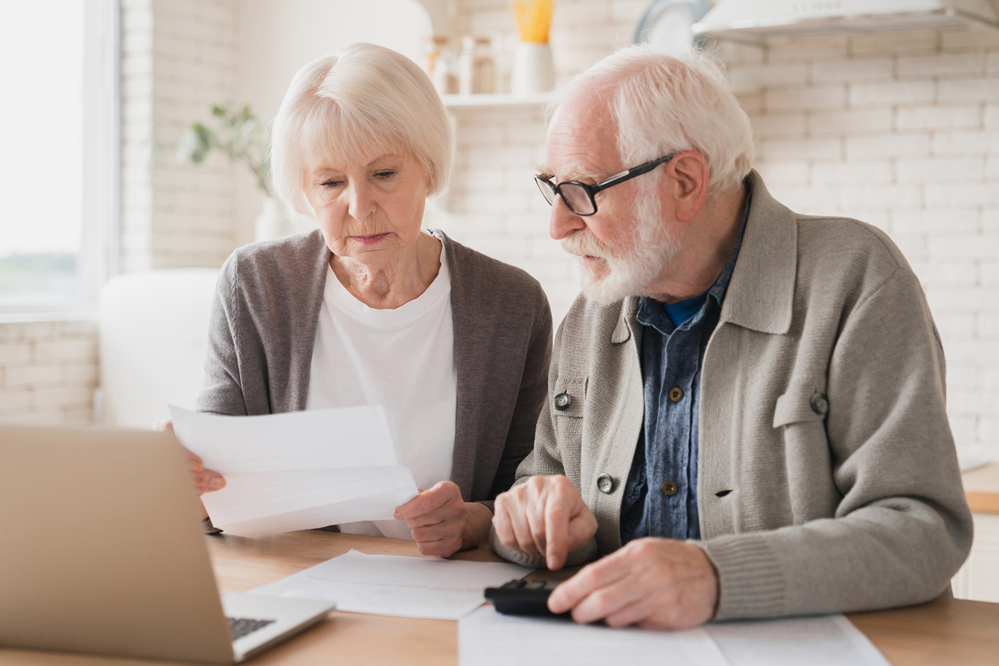Photo of couple looking at paperwork in a light filled room