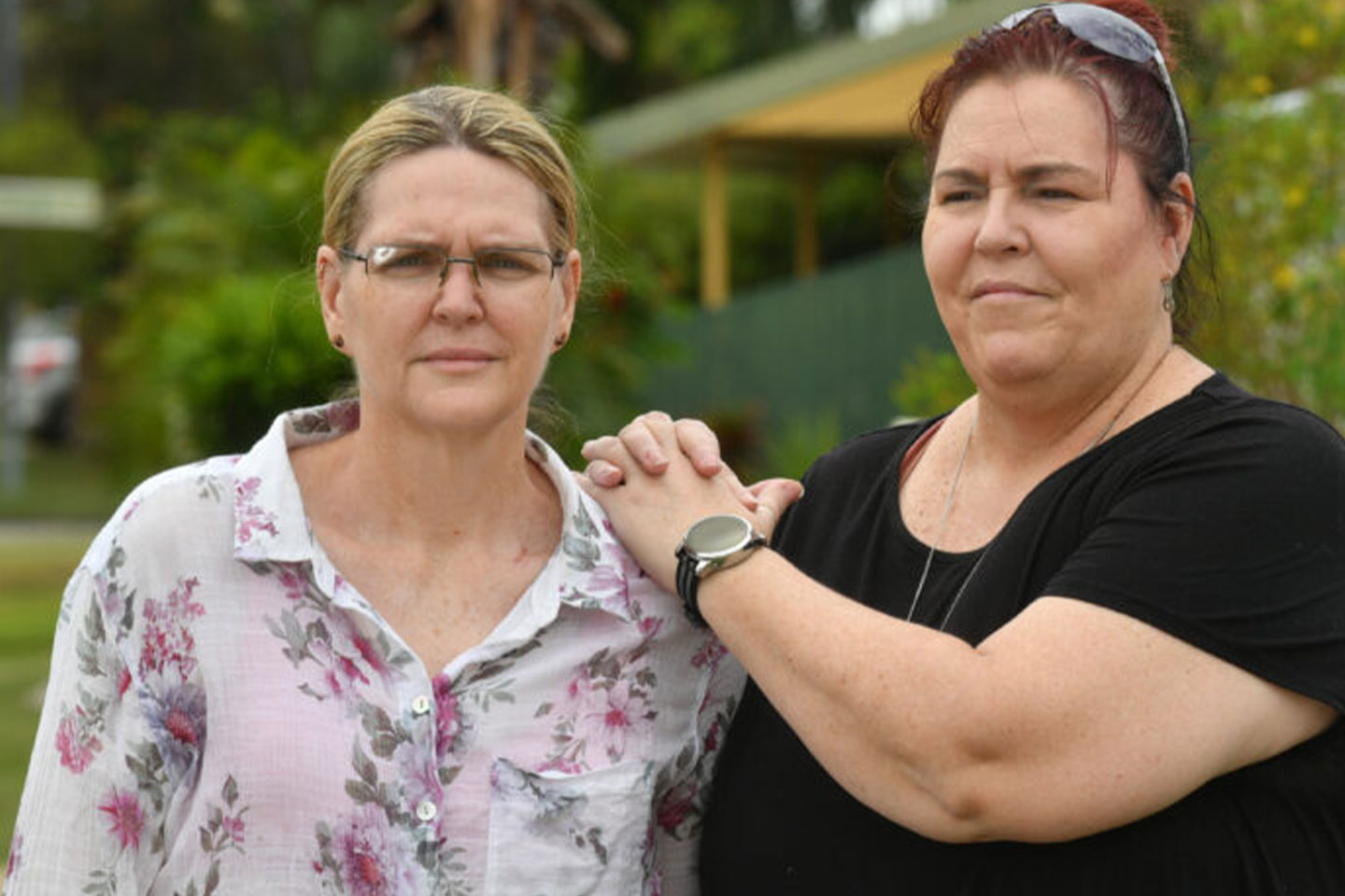 Photo of two women standing together outdoors