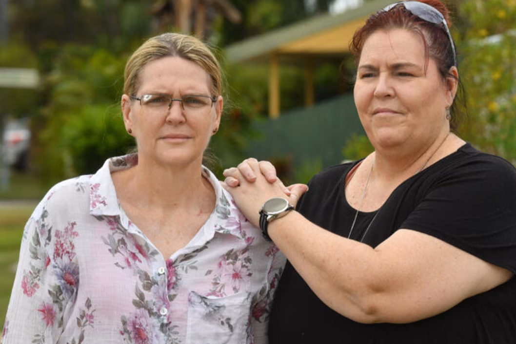 Photo of two women standing together outdoors