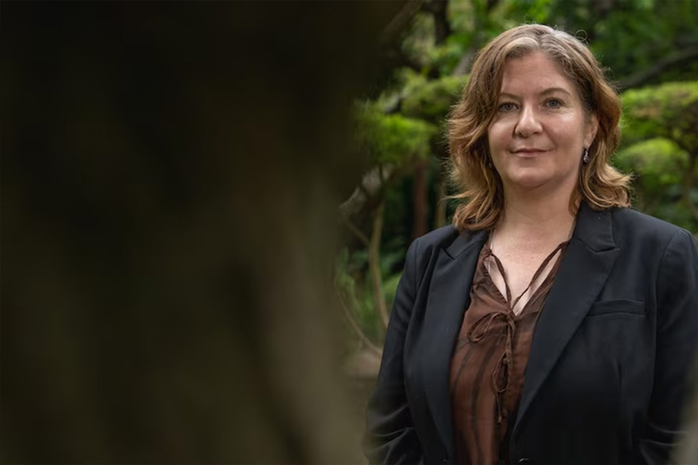 Photo of a woman outdoors wearing a black jacket