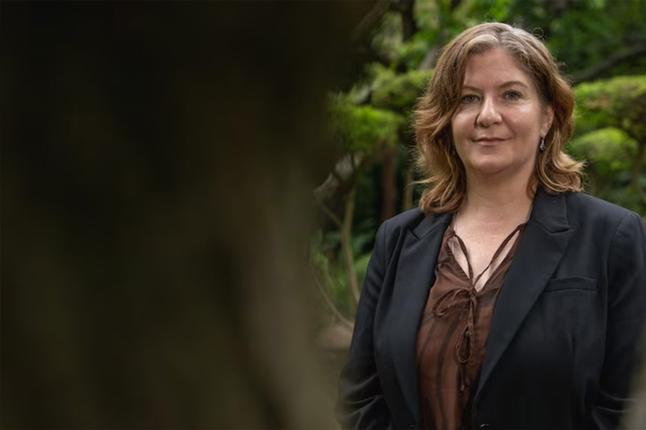 Photo of a woman outdoors wearing a black jacket