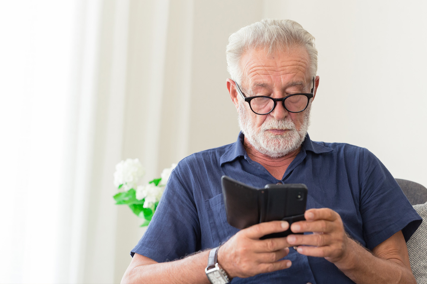 Photo of a man looking at his mobile phone