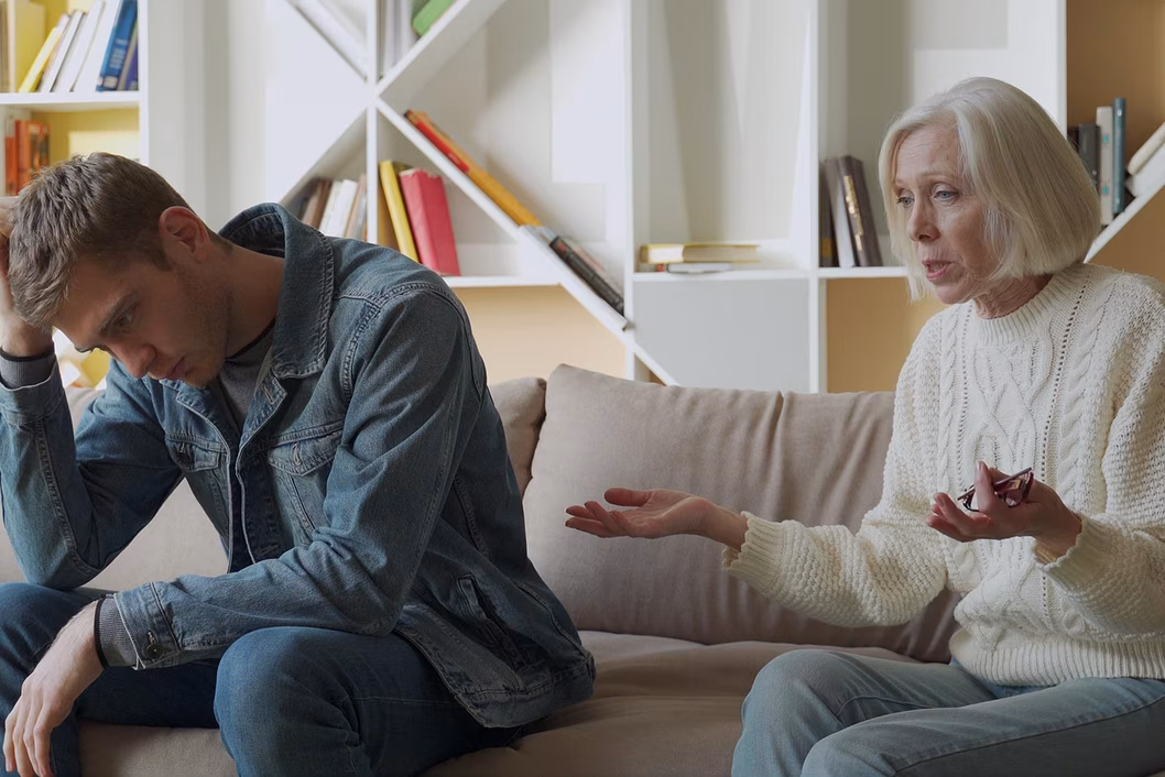 Photo of woman and young manvwearing double denim on a couch