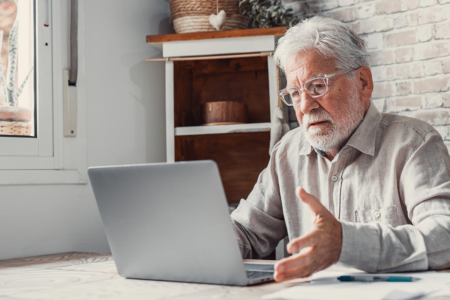 Photo of a man sitting in front of a lap top