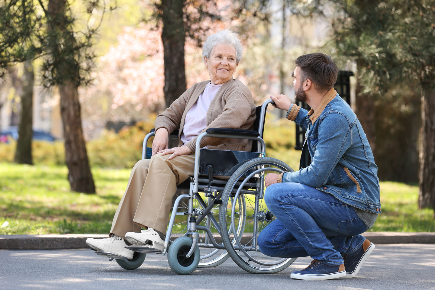 Senior woman in the park with young man 
