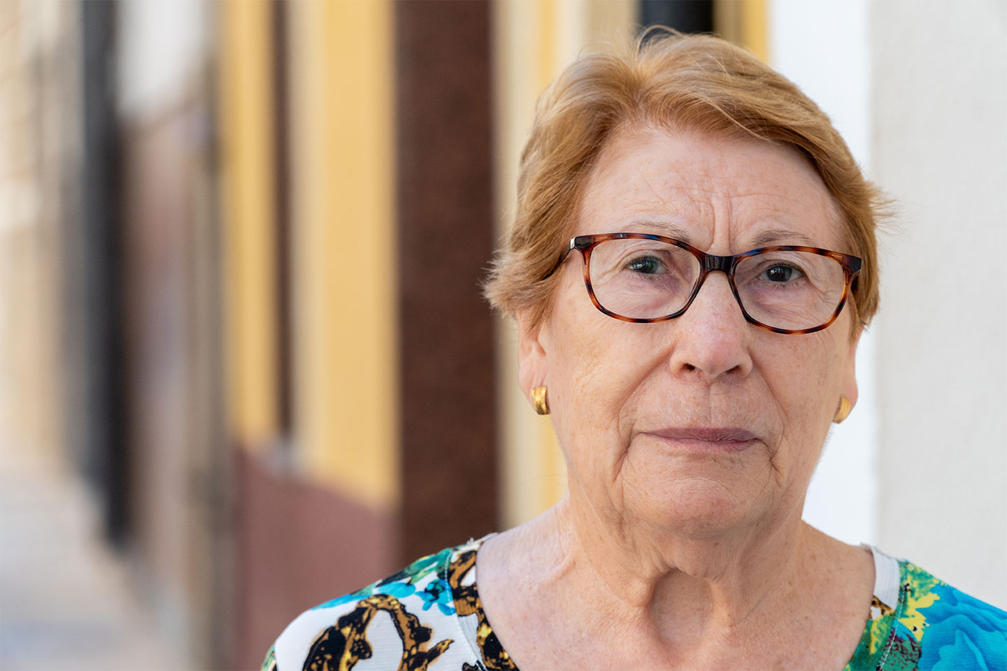 Photo of a woman with tortoiseshell glasses