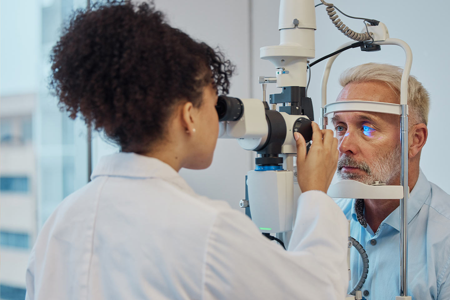 Photo of an optometrist checking a man's eyes with a machine