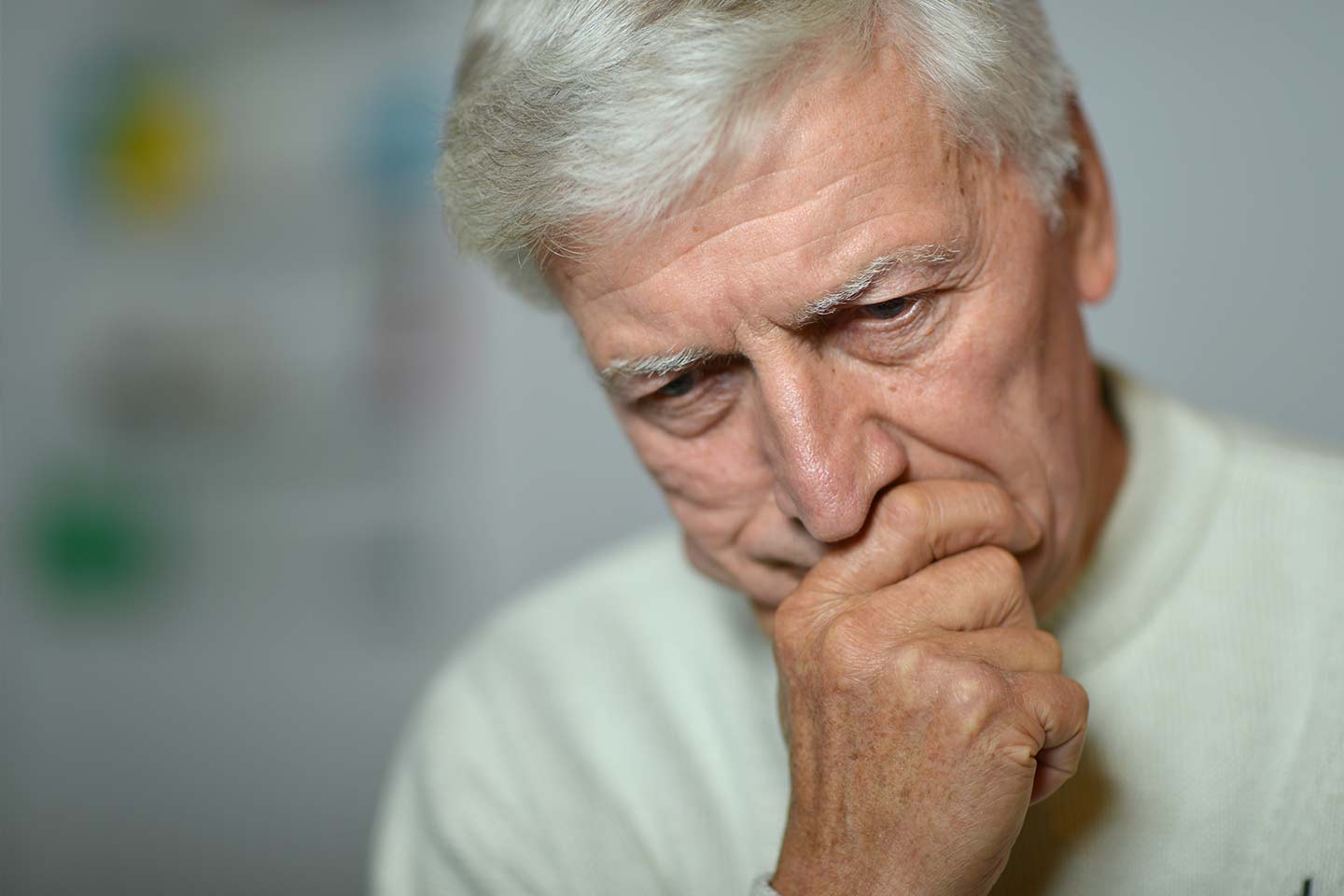 Photo of man looking concerned with chin in hand