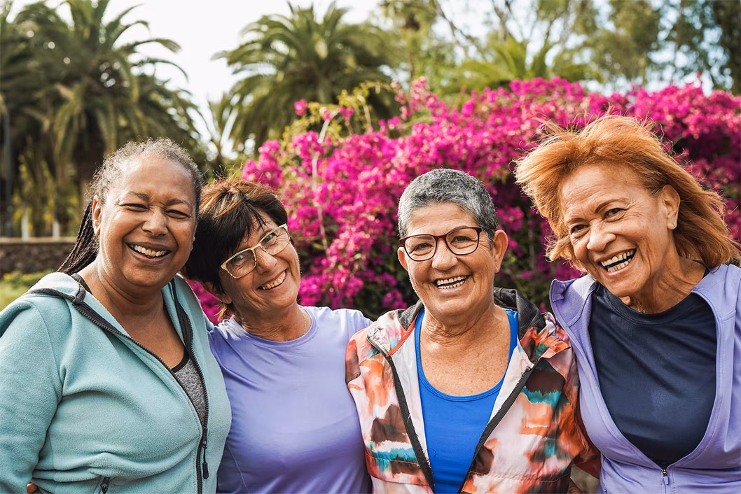 Photo of a group of diverse women laughing outdoors