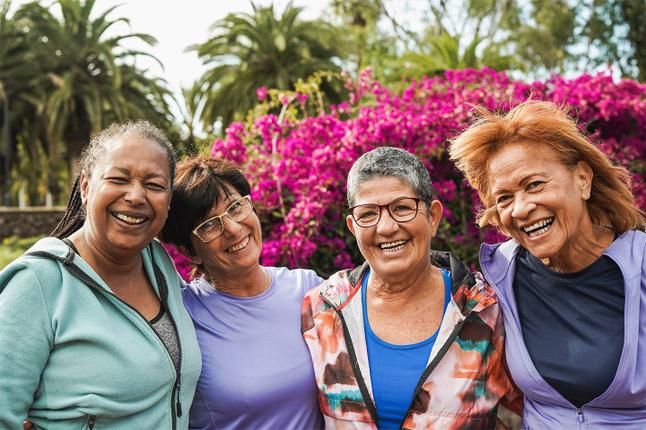 Photo of a group of diverse women laughing outdoors