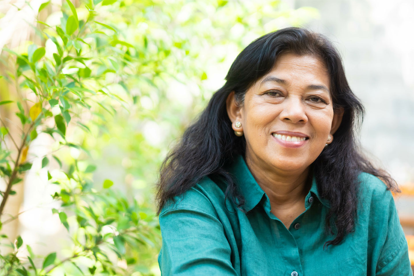 Woman with long dark hair is smiling