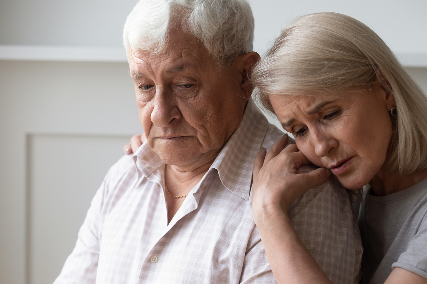 Photo of sad-looking woman comforting a man