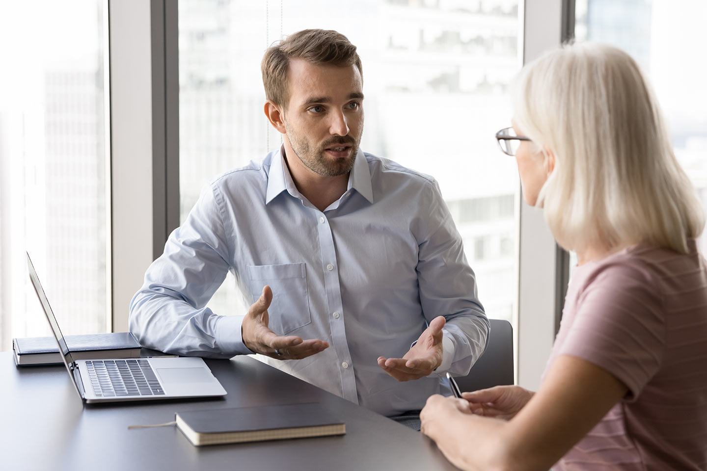 Photo of a seated man and woman with a laptop