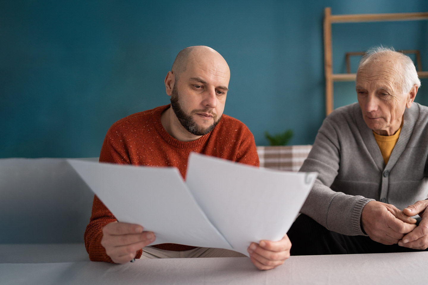 Image of a father and a son reviewing some paperwork