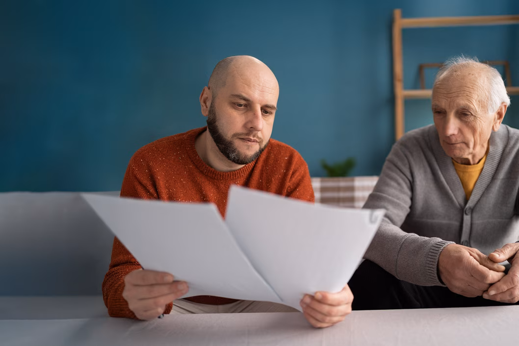 Image of a father and a son reviewing some paperwork