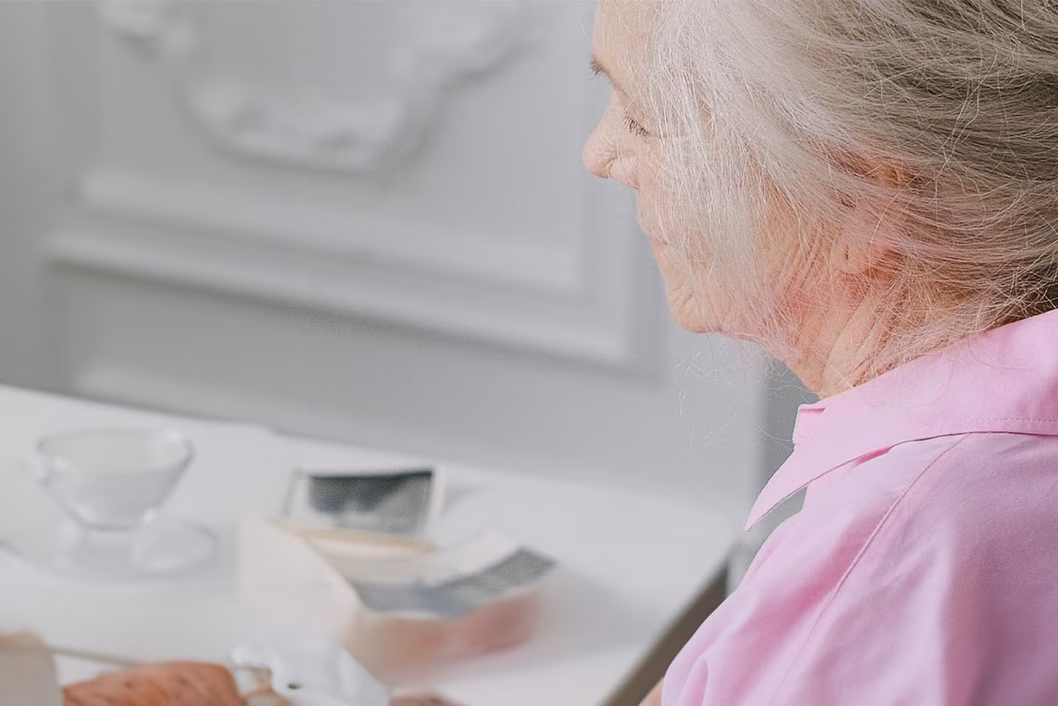 Photo of white-haired lady in a pink shirt