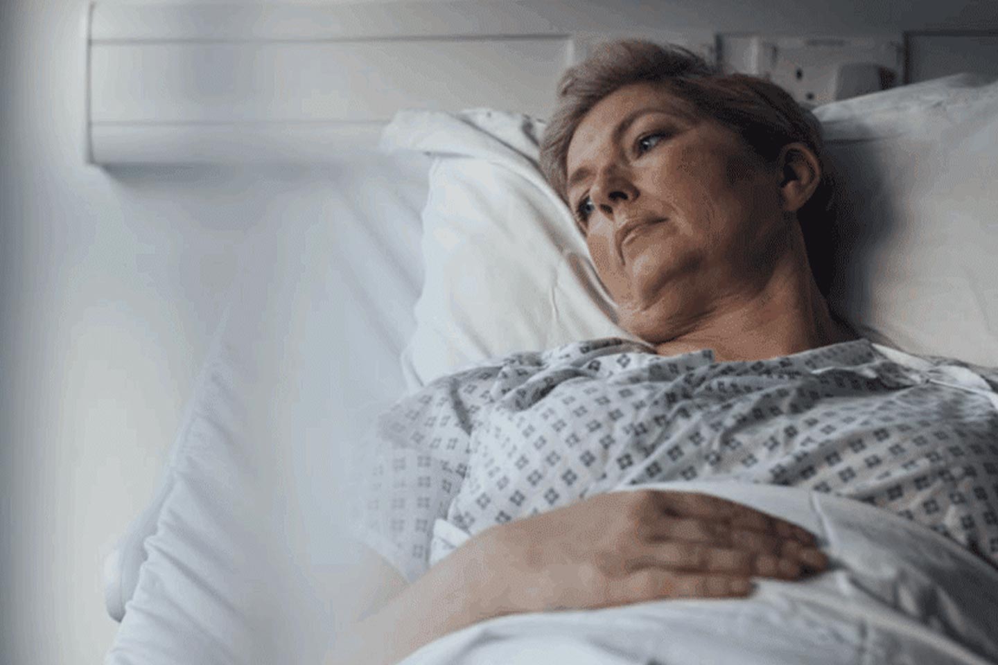 Photo of a woman lying in a hospital bed