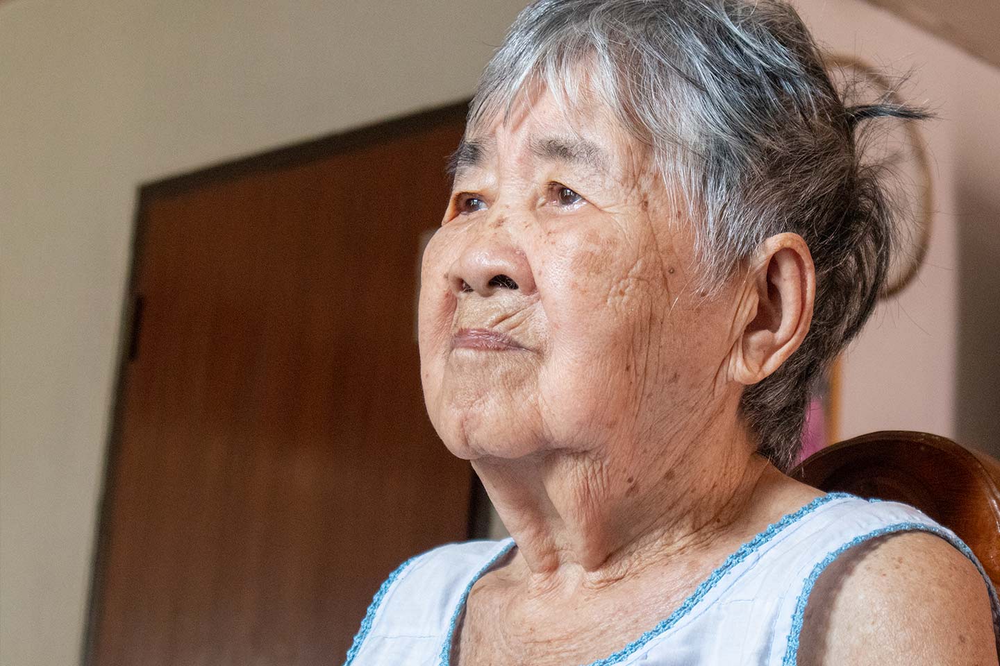 Photograph of a woman wearing a pale blue vest