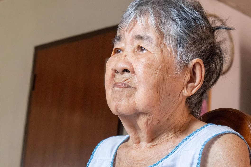 Photograph of a woman wearing a pale blue vest