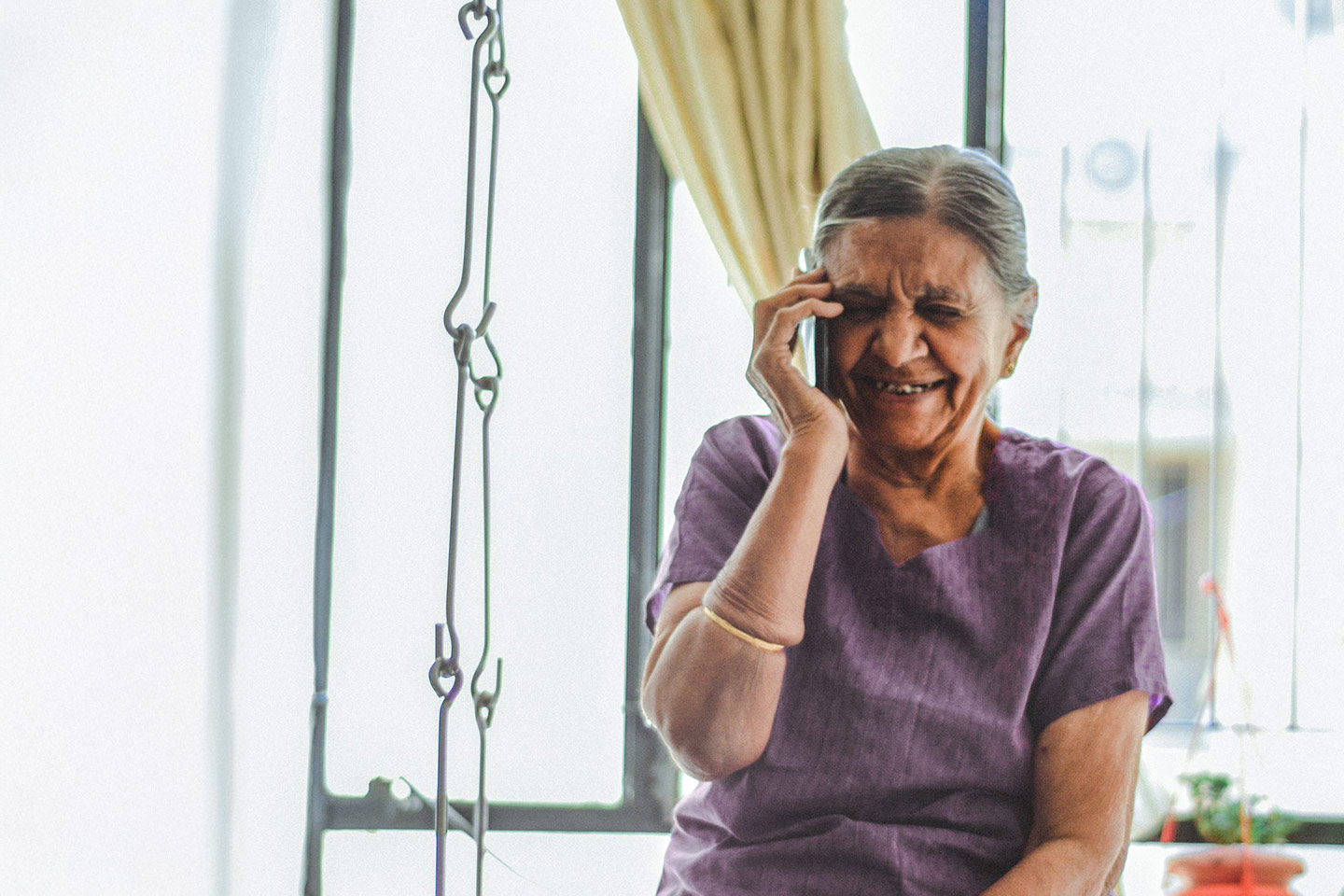 Photo of woman wearing a purple top and a cream bracelet