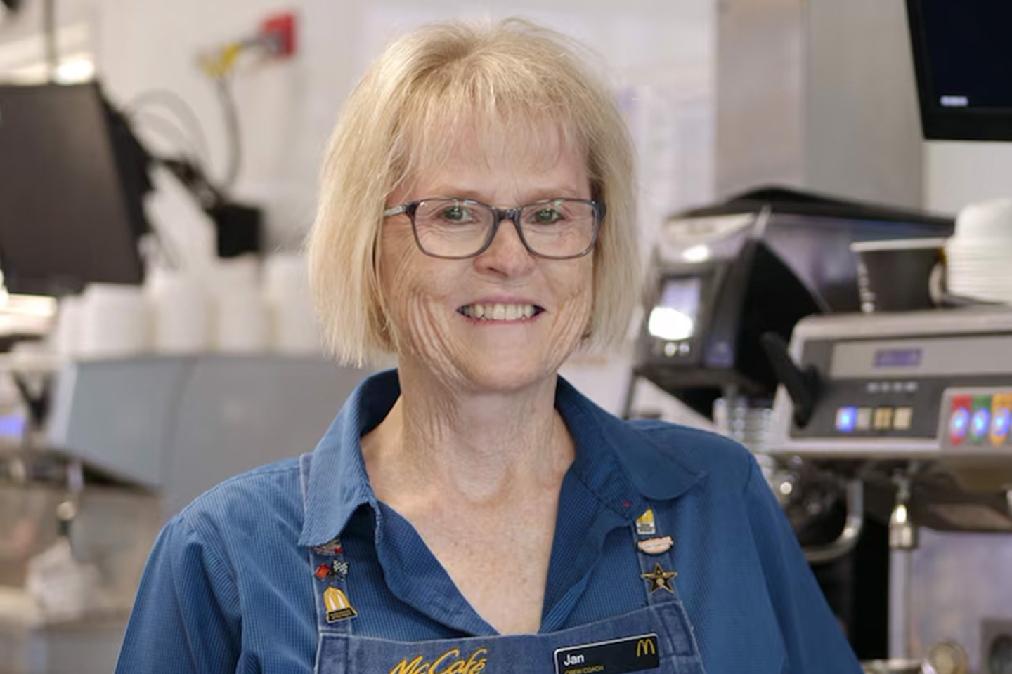 Photo of a woman wearing glasses and a denim shirt