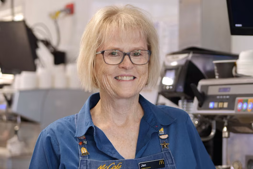 Photo of a woman wearing glasses and a denim shirt