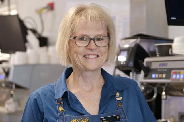 Photo of a woman wearing glasses and a denim shirt