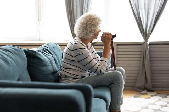 Senior woman sitting on her couch
