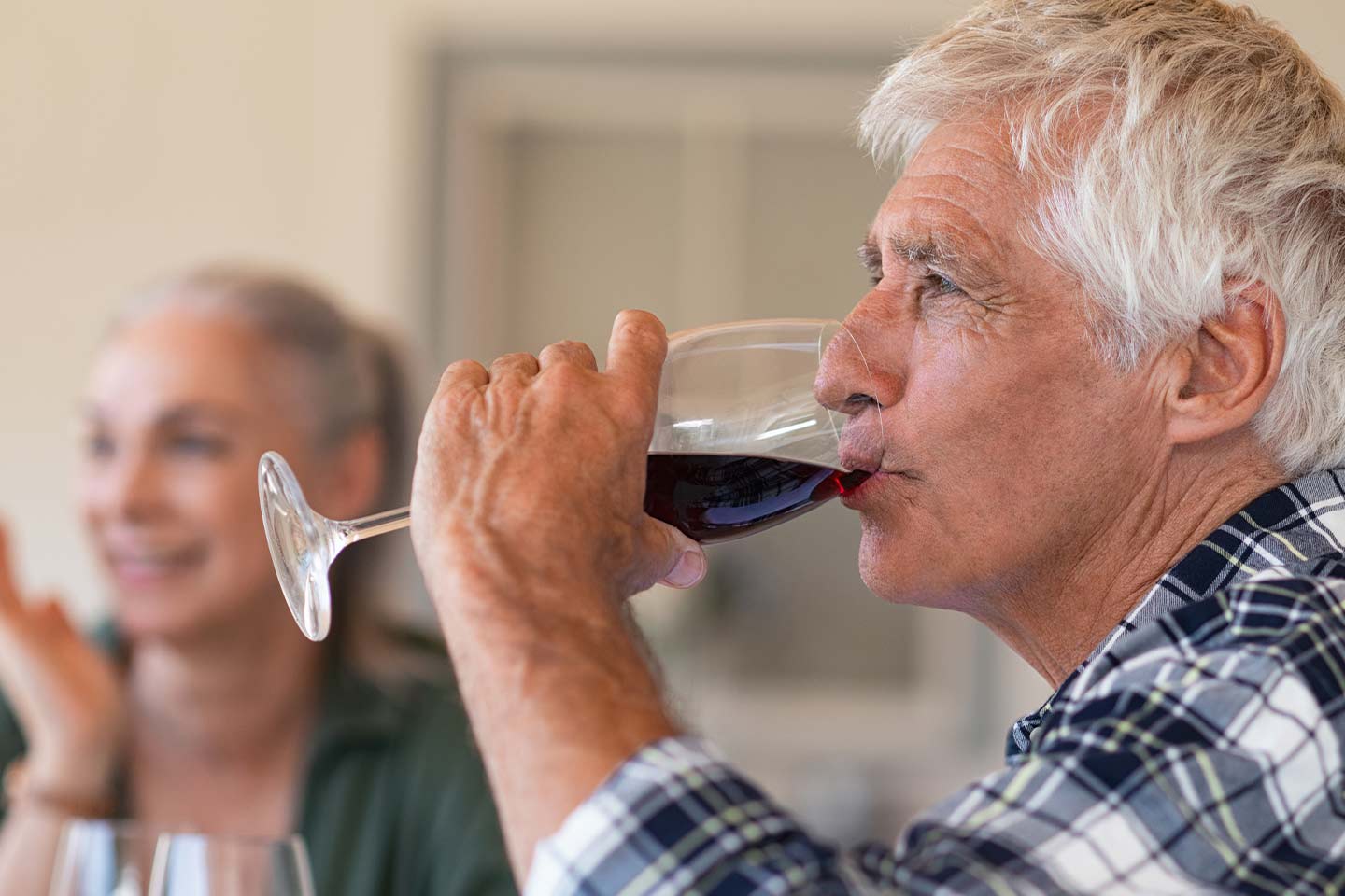 Photo of a man drinking a glass of red wine