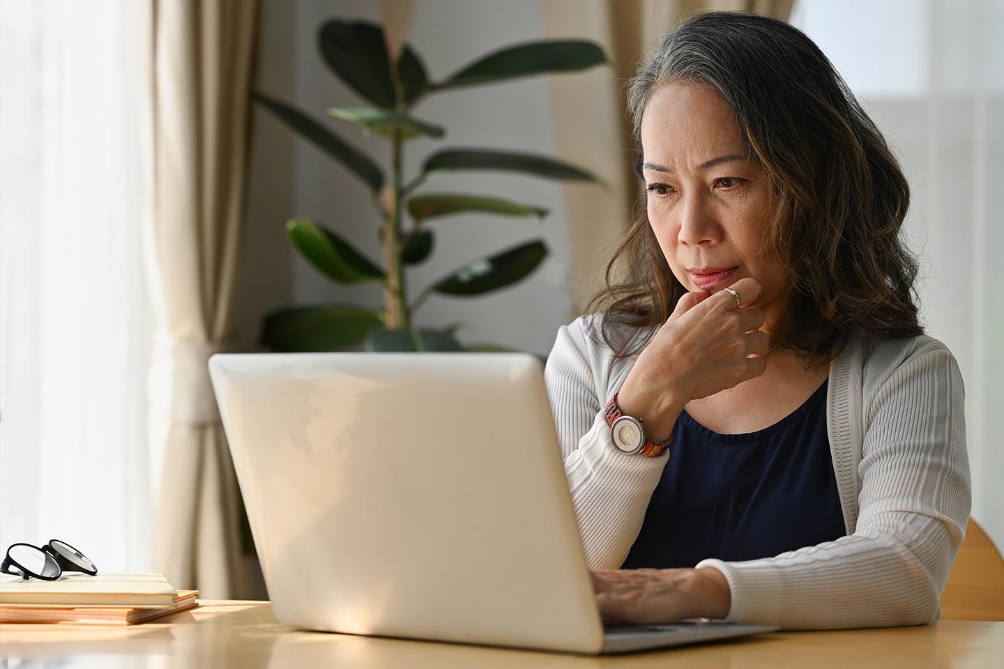 Photo of a woman sitting in front of a laptop