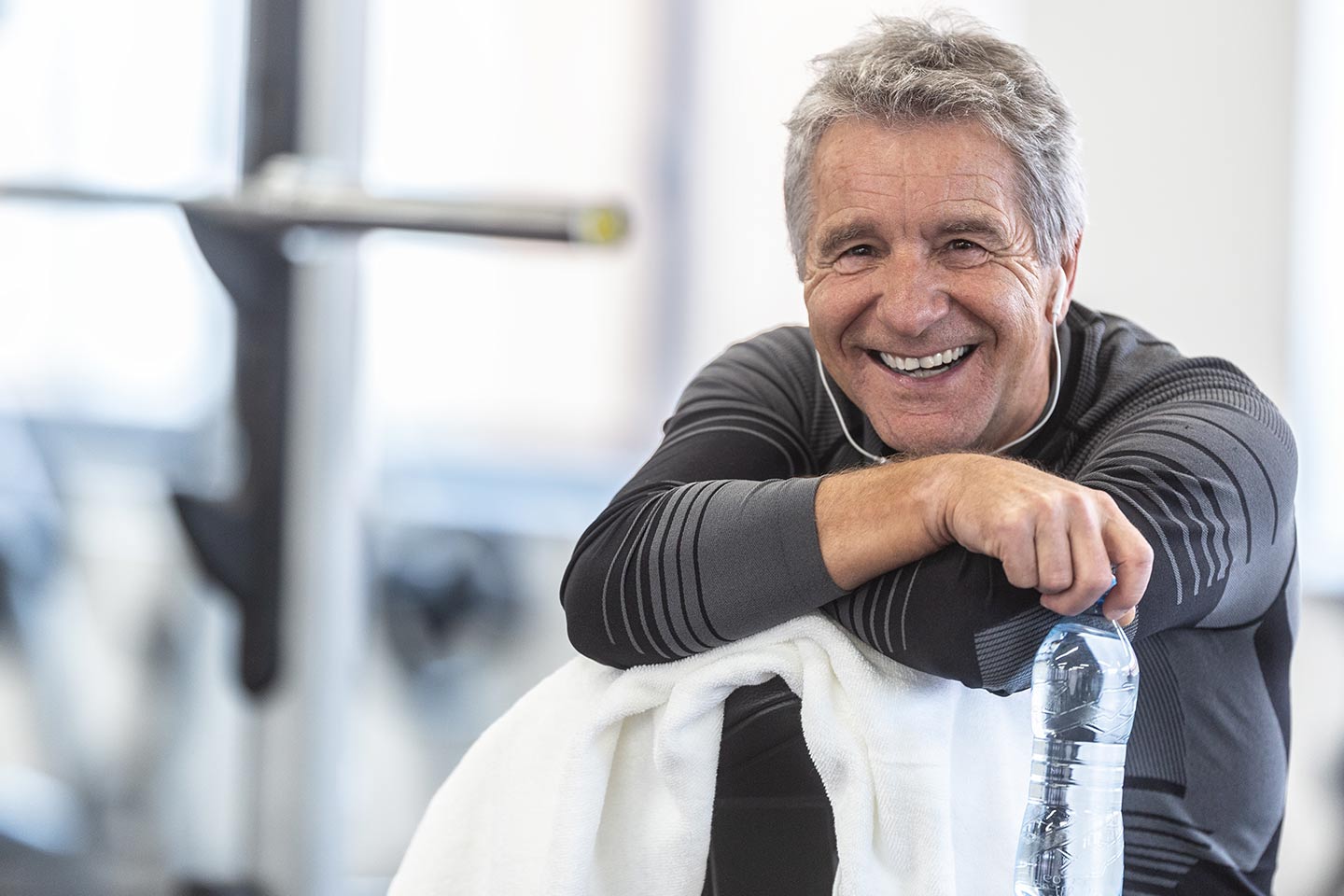 Photo of smiling man wearing grey in a gym